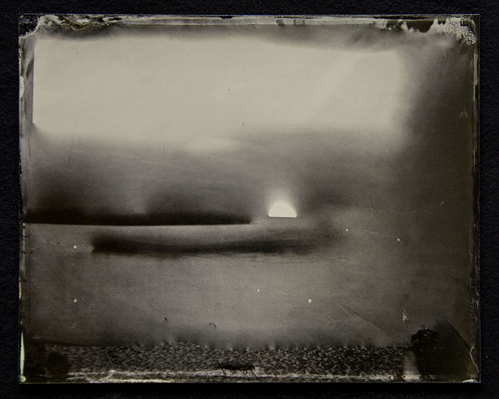 Bright, warm silvers above. Warm undulating greys at center disrupted by brights drops and dark dashes. Dark grey, pebbled texture at bottom.