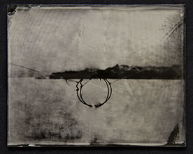 Landscape becomes abstract field of bright silver /w moire pattern. Dark fine gestures form a circle @ctr intersected by broad stroke of horizon