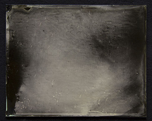 Panel B3: Landscape photo on glass defies recognition. becomes dark grey field w/ black swirls & smaller swirls & dashes of medium silver grey.