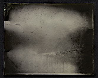 Panel C1: Landscape photo on glass. Silvery greys emerge from blacks to form passages of hard surfaces & insubstantial gases peppered /w black.