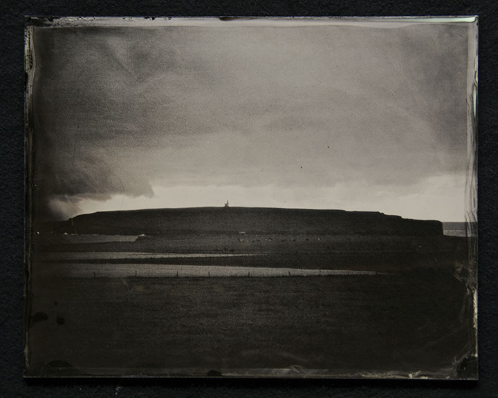 Panel B1 is a glass photo depicting a landscape. The composition is 1/2 bright clouds with dark edges. The other 1/2 dark fertile land of hills.