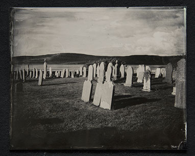 Panel B3 depicts a landscape full of tall, thin gravestones. Three in the foreground glow white from the sun. Rolling hills crown the distance.